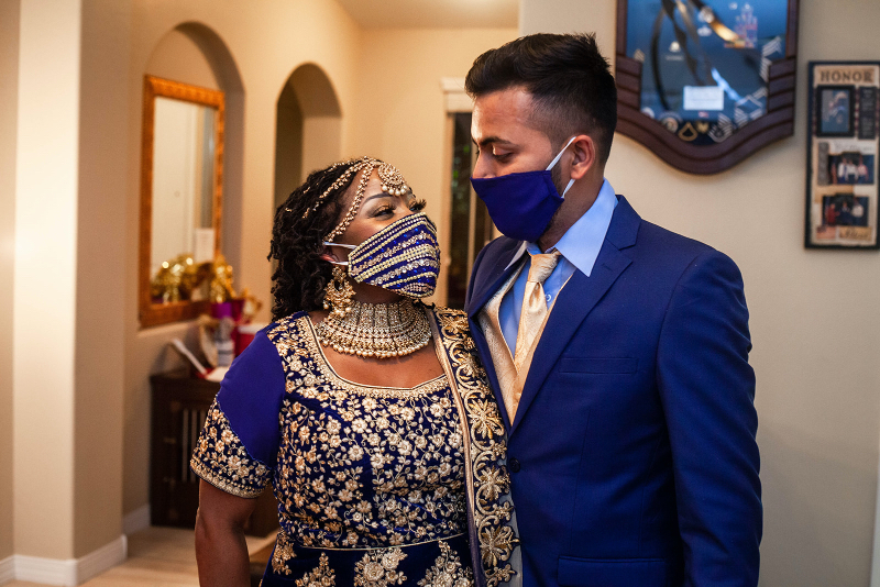 Airbnb wedding couple in stunning blue and gold wedding attire