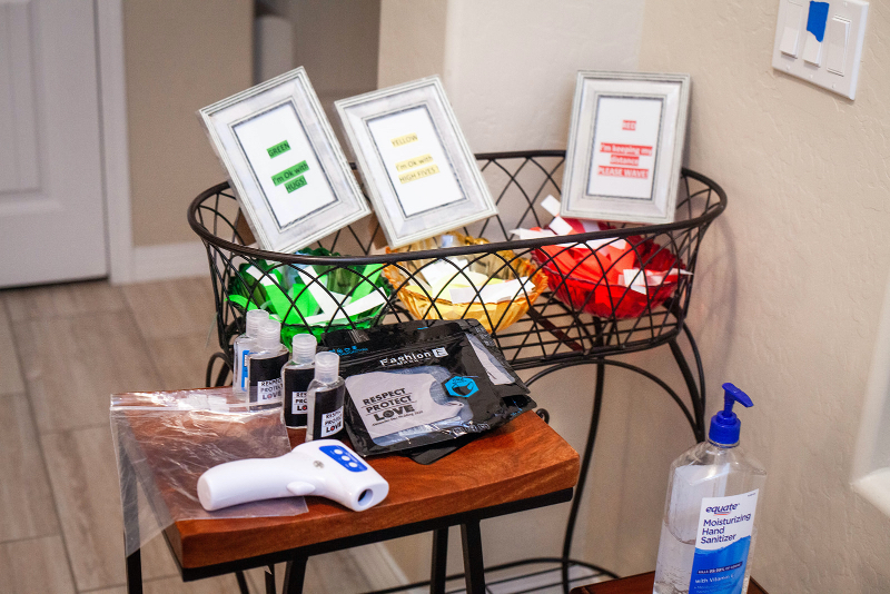 COVID wedding signage with wristbands, masks, and hand sanitizer