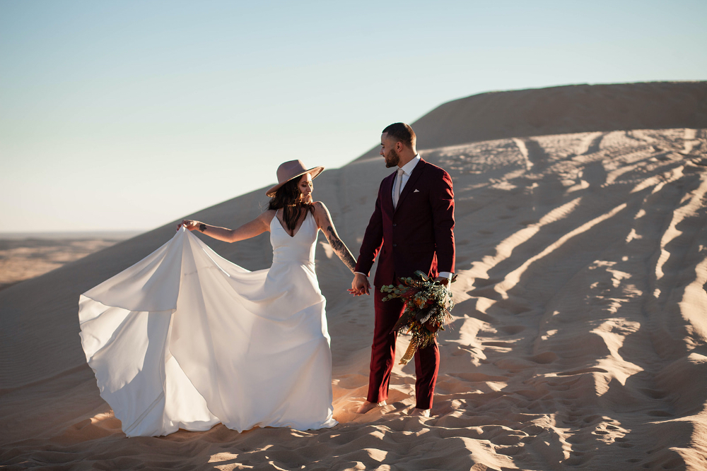 Desert Elopement in Arizona with bright florals and flowy dress