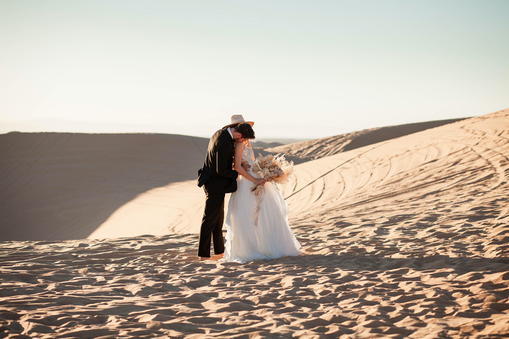 Sunset photos in Arizona desert elopement with bride and groom