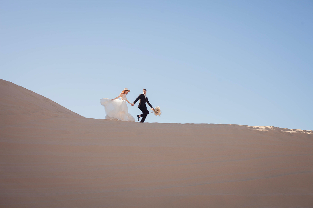 Desert Elopement in Arizona with bride and groom on top of a hill