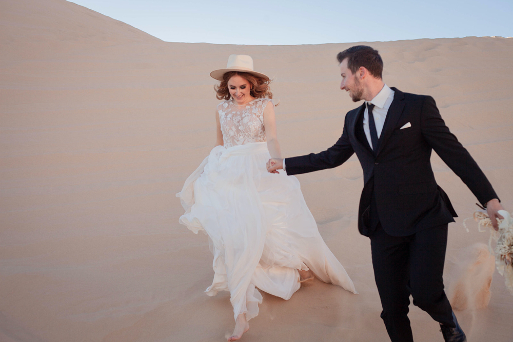 Bride and groom walking in desert elopement