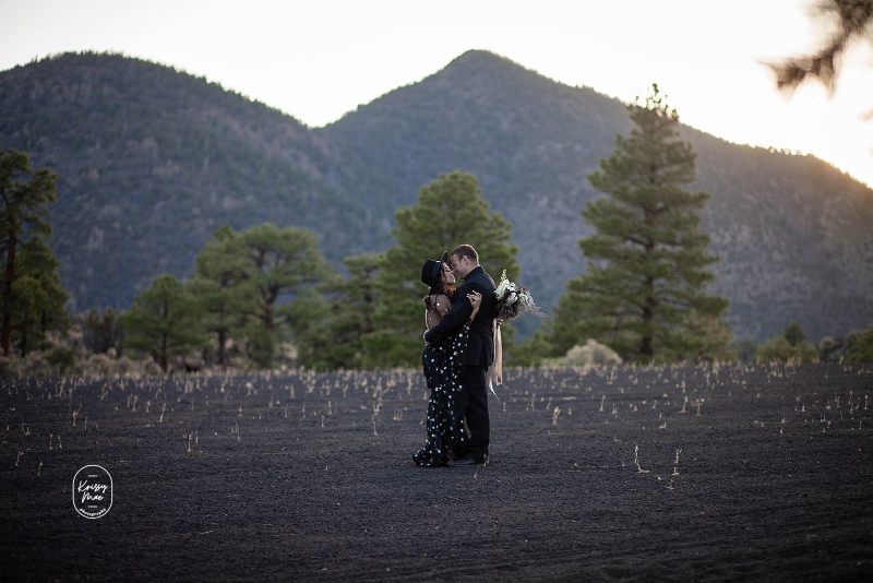 Groom dances with bride in black dress at Arizona desert elopement